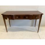 A late Georgian shape fronted mahogany serving table, fitted three frieze drawers with cast brass