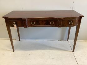 A late Georgian shape fronted mahogany serving table, fitted three frieze drawers with cast brass