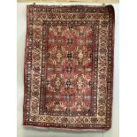 A Caucasian style red ground rug, 210 x 156cm