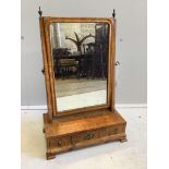 An 18th century walnut veneered dressing table mirror, on plinth fitted with three small drawers,