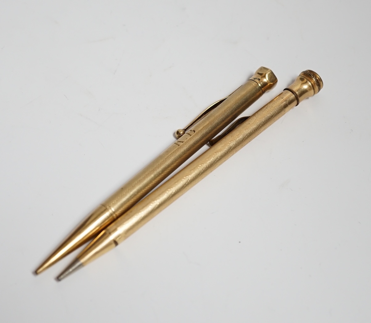 A 9 carat? (marks rubbed) pencil and another rolled gold pencil