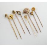 Eight assorted early 20th century and later yellow metal and gem set stick pins, including six 15ct,