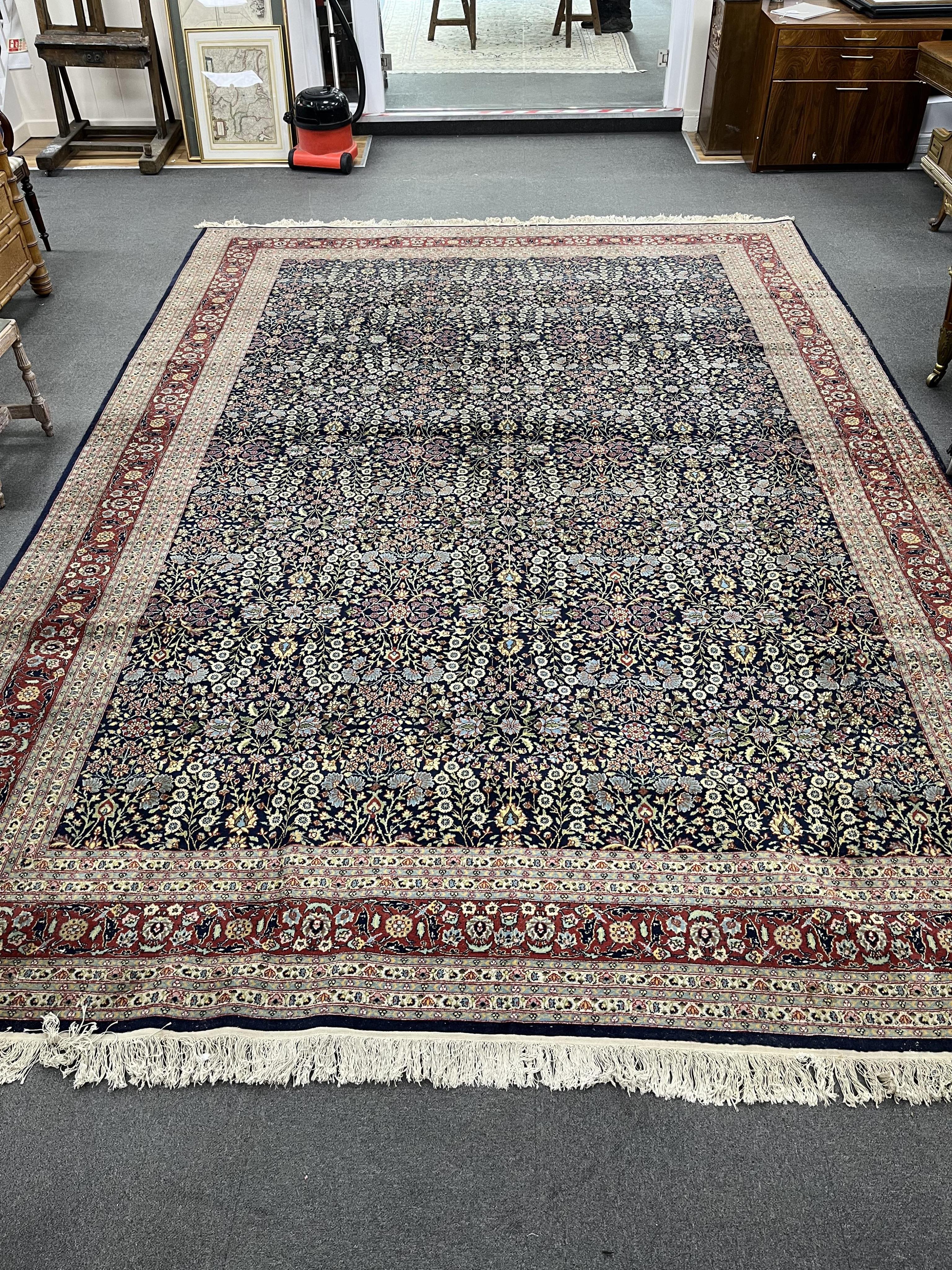 A Turkish Hereke blue ground carpet, 425 x 294cm