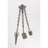A late 19th century pierced silver plated chatelaine, hung with three accoutrements, to include a