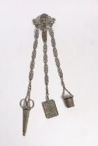 A late 19th century pierced silver plated chatelaine, hung with three accoutrements, to include a