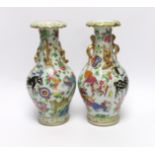 A pair of 19th century Chinese famille rose ‘mythical beasts’ vases, 24cm