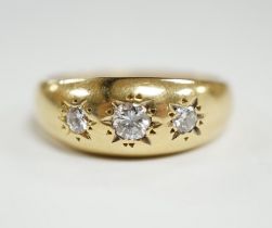 A modern 18ct gold and gypsy set three stone diamond ring, size S, gross weight 7.9 grams.
