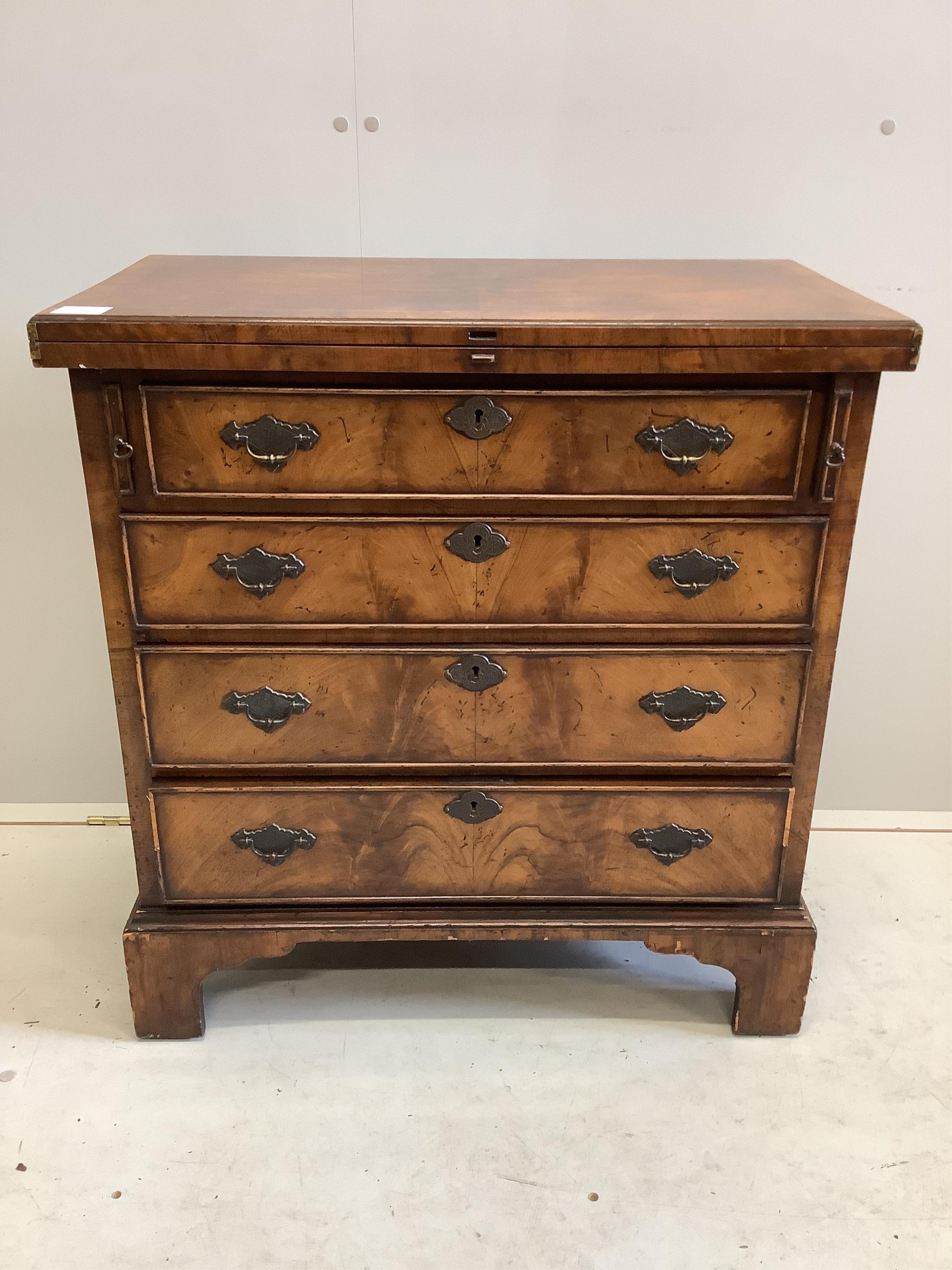 A good quality reproduction feather-banded walnut batchelor’s chest of four drawers, raised on