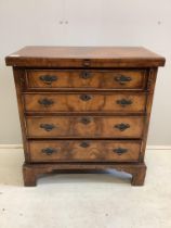 A good quality reproduction feather-banded walnut batchelor’s chest of four drawers, raised on