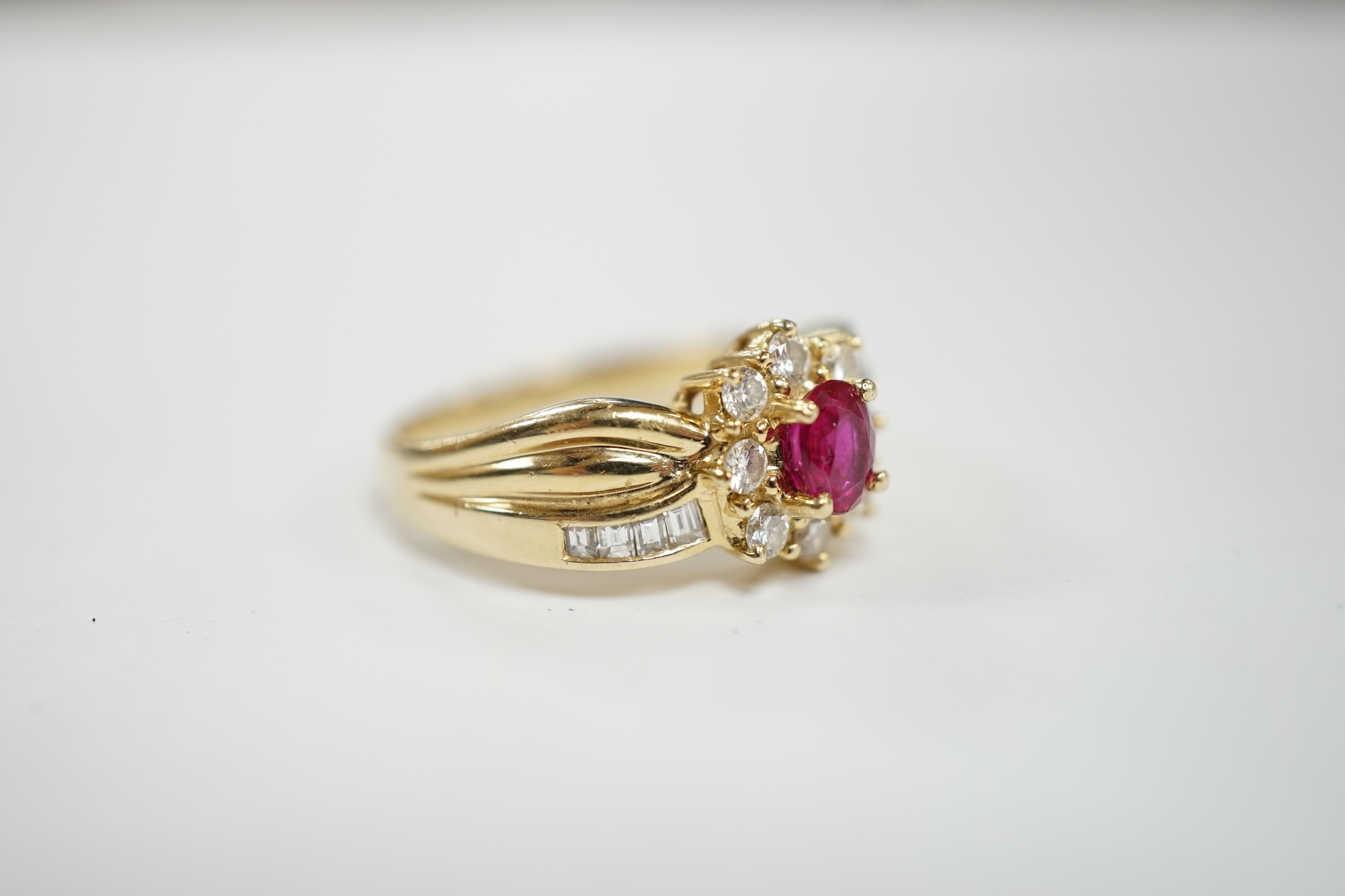 A modern 14k, ruby and diamond set oval cluster dress ring, with diamond chip set shoulders, size P, - Image 3 of 4