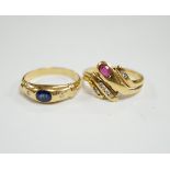 A modern 750 yellow metal and gypsy set single stone sapphire and two stone diamond set ring, size