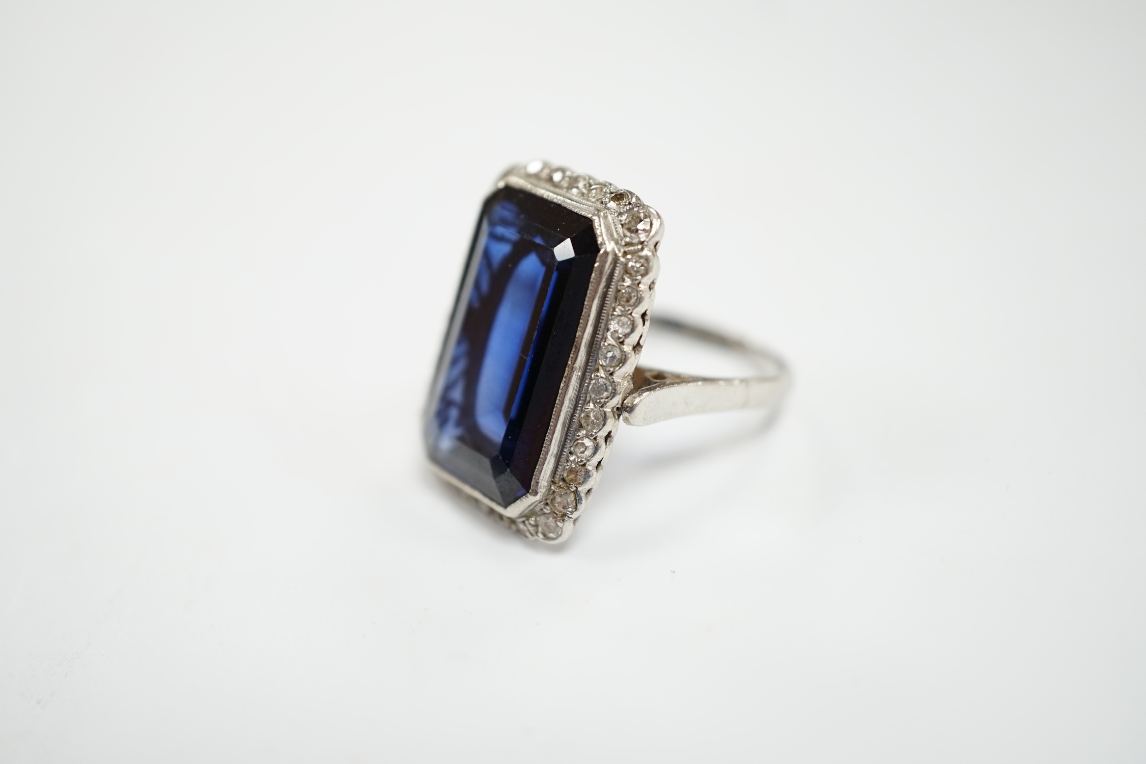 A 1920's white metal and single stone emerald cut synthetic sapphire set dress ring, with millegrain - Image 2 of 5