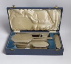 A cased George VI silver mounted four piece dressing table set, by Walker & Hall, Sheffield 1937.