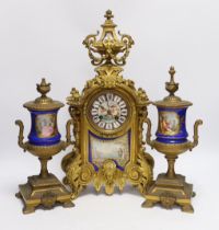 A Sevres style ormolu clock, Miller & Sons with two similar gilt spelter urns, pendulum no key,