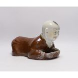 A Chinese porcelain ‘boy’ headrest, 29cm long