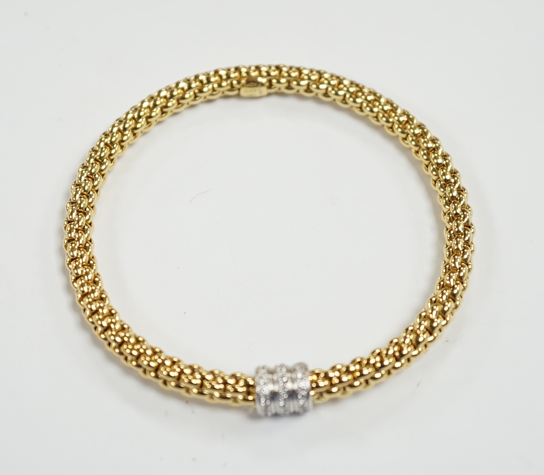 An Italian 18kt Fope flexible bracelet, with diamond chip set barrel shaped motif, gross weight 17.1