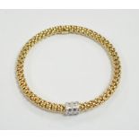 An Italian 18kt Fope flexible bracelet, with diamond chip set barrel shaped motif, gross weight 17.1