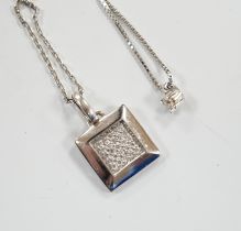 A modern Italian 18k white metal and diamond chip set pendant, on an 18k chain, 42cm and a white