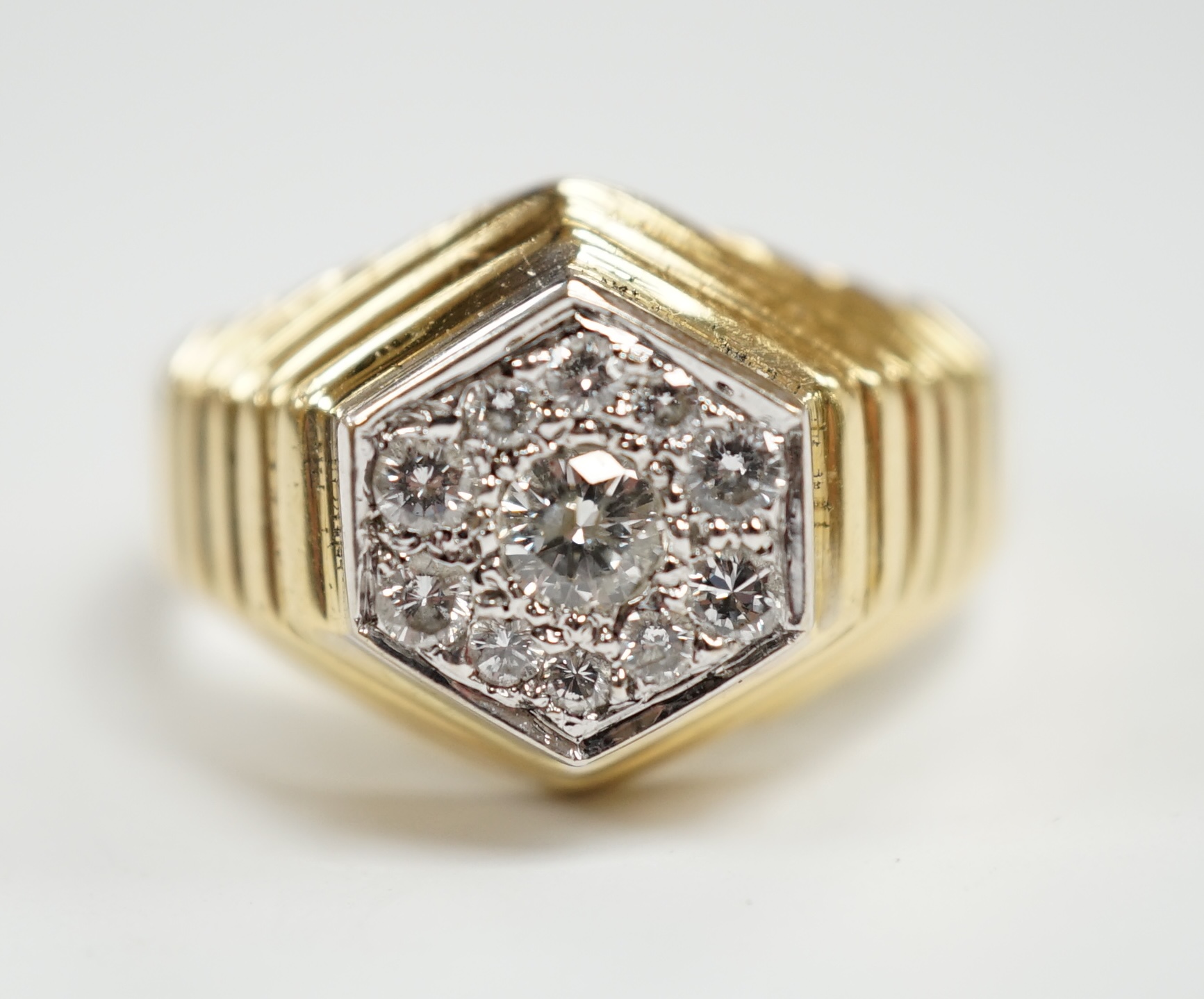 A modern 18ct gold and diamond set hexagonal cluster ring, size Q, gross weight 11.3 grams.