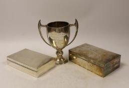 A 1930's Art Deco silver two handled presentation trophy cup, by Mappin & Webb, 15.6cm, and two