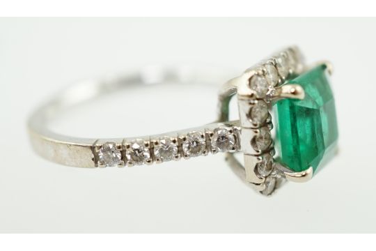 A modern 18k white gold, emerald and diamond set square cluster ring, the central square cut emerald - Image 4 of 5