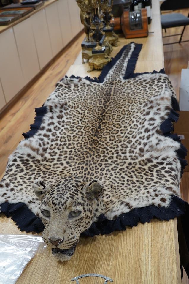 An early 20th century leopard skin rug with taxidermy head by van Ingen ...