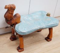 A carved wood foot stool in the form of a camel, blue stamped patterned leather cushion, 56cm