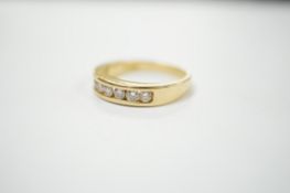 A modern 18ct gold and seven stone channel set diamond half hoop ring, size O, 5.2 grams.
