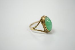 A Chinese 18k and cabochon jade set ring, size O, gross weight 3.9 grams. Condition - poor