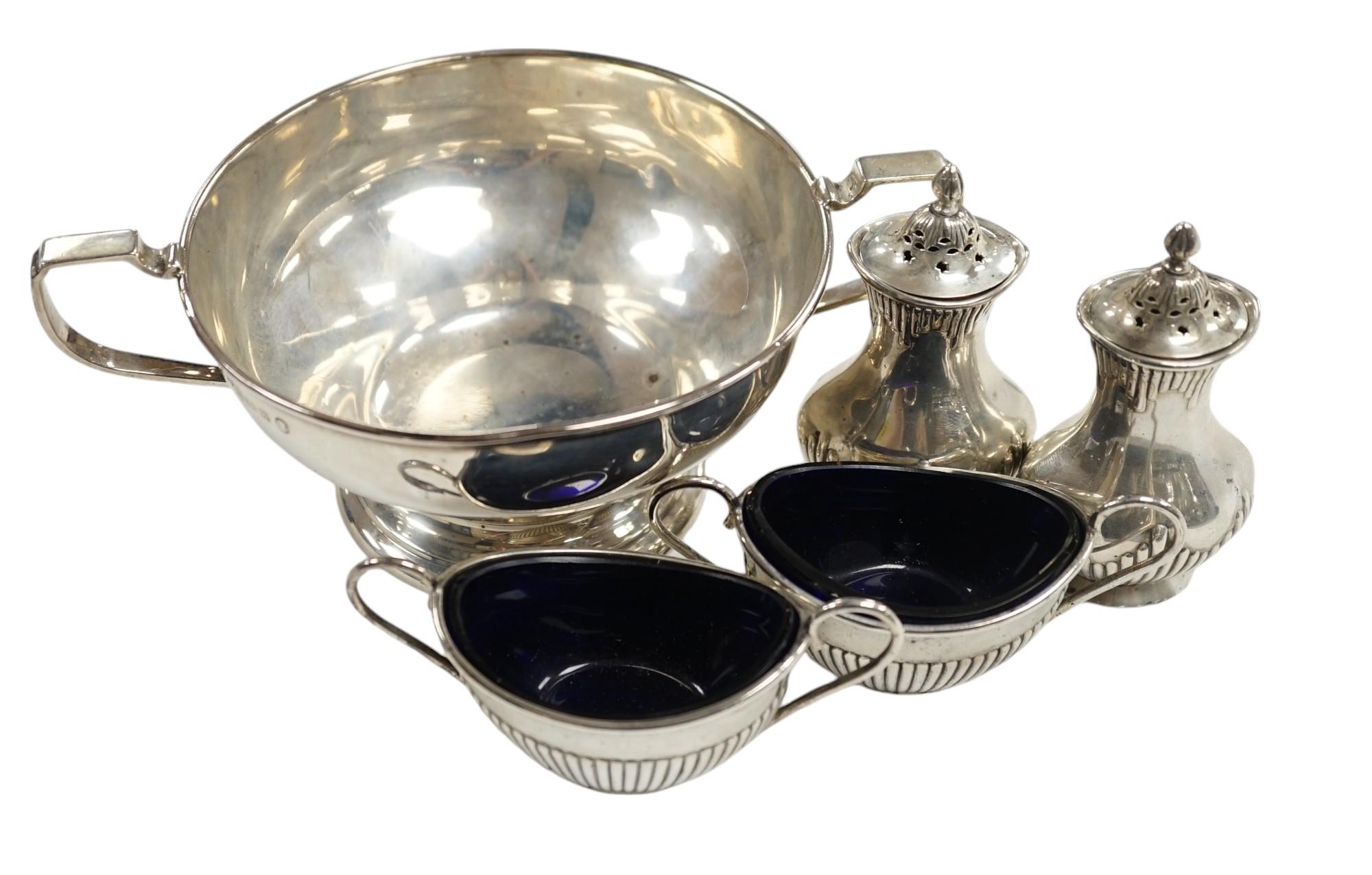 A George V silver two handled bowl and two pairs of early 20th century silver condiments.