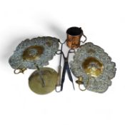 A pair of brass repousse wall sconces, a copper two handle mug, a small brass sun dial, a pair of