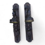 A pair of French bronze wall lights, c.1900 decorated with masks, mounted on wooden plinths, 54cm
