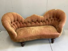A Victorian double spoon back settee recently re-upholstered in buttoned patterned red and gold