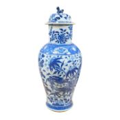 An early 20th century Chinese blue and white dragon vase and cover, 42cm high. Condition - crack and