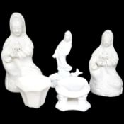 Three blanc de chine figures, one octagonal blanc de chine cup and a similar stand, largest 15cm