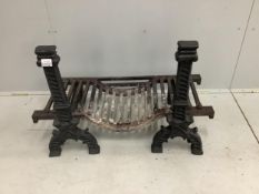 A pair of black painted cast iron fire dogs, a fire basket and a wrought iron fender. Condition -