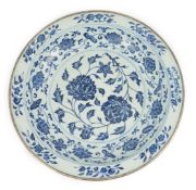 A large Chinese Ming style blue and white dish, possibly 18th century, painted with peony sprays