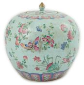 A Chinese turquoise ground famille rose jar and cover, late 19th century, painted with butterflies
