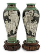 A pair of Chinese black ground enamelled porcelain baluster vases, late 19th century, each painted