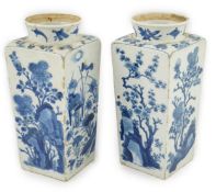 A pair of Chinese blue and white square section vases, Kangxi period, each side variously painted