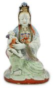 A Chinese enamelled porcelain group of Guanyin holding a child, Qianlong period, seated in