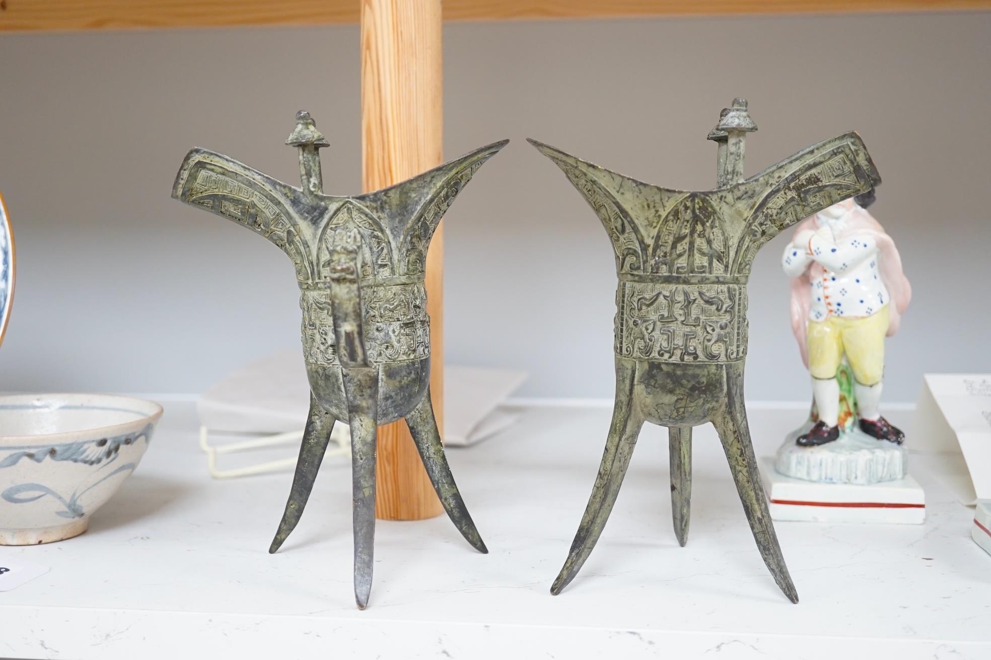 A pair of Chinese archaistic bronze vessels on tripod legs, jue, 20.5cm high. Condition - fair. - Image 2 of 7