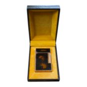 A cased Dupont 'gold dust' lighter with booklet. 6.3cm high. Condition - good