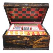 A Victorian coromandel games box with accessories, ivory chess pieces and counters, box 36cm wide