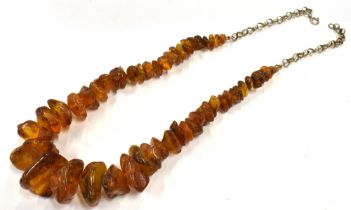 RAW AMBER & SILVER NECKLACE 50cm long, comprising numerous raw amber pieces, approx 8.6-23.3mm, on