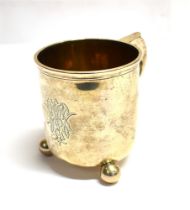 VICTORIAN SILVER TANKARD Standing 9.3cm high, on orb feet with scroll handle, monogram one one side.