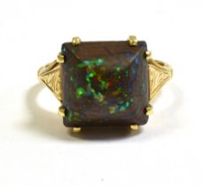 BOULDER OPAL DRESS RING Handmade in 18ct gold, with a twin claw set square cabochon boulder opal,
