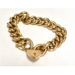 A STAMPED 9CT ROSE METAL CURB LINK BRACELET With stamped 9.375 Birmingham Heart padlock with