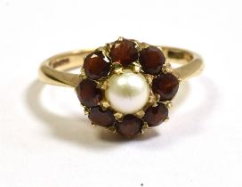 PEARL AND GARNET CLUSTER RING In 9ct gold, with a central 4.2mm half pearl surrounded by a circlet