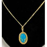 TURQUOISE PENDANT ON CARTIER CHAIN A natural, intense sky blue turquoise oval cabochon, approx 16.